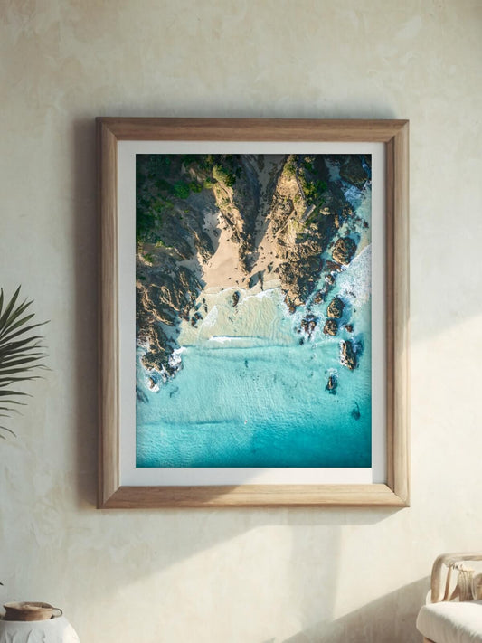 Framed aerial coastal photography print of The Pass Byron Bay on a wall
