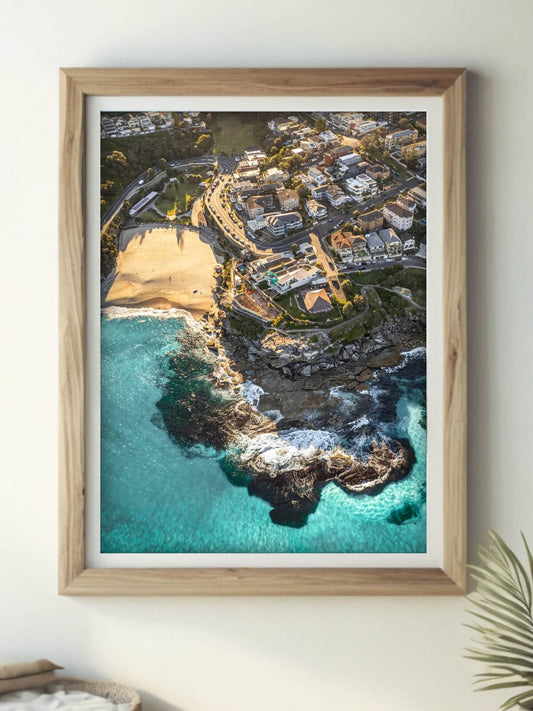 Framed aerial photography print of Tamarama Beach Sydney on a wall