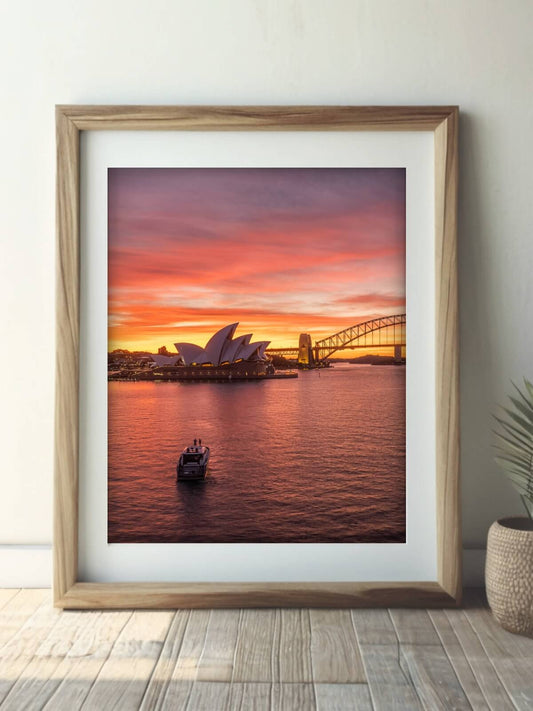Framed aerial photography print of Sydney Harbour at sunset on a wall