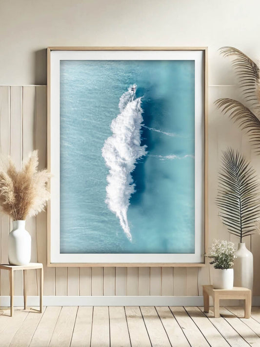 Framed aerial surf photography print of a surfer's wake at Bronte Beach on a wall