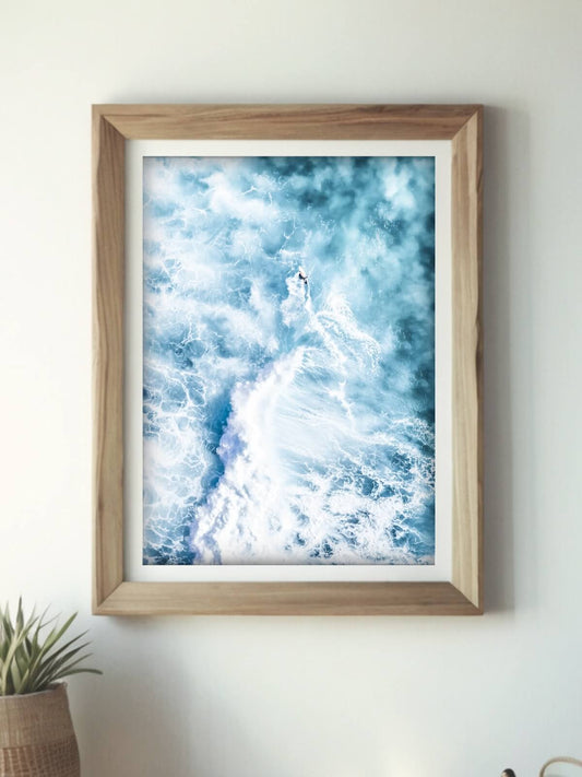 Framed aerial surf photography print of a breaking wave at Bronte Beach on a wall