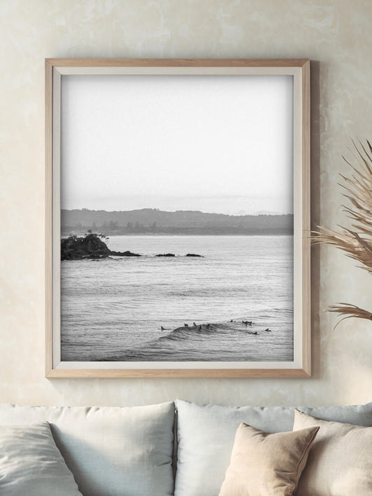 Framed black and white surf photography print of Wategos Beach Byron Bay on a wall