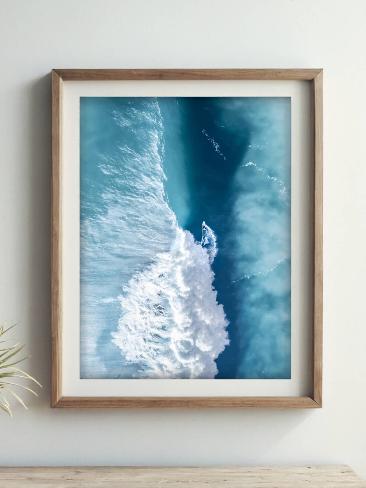 Framed aerial surf photography print of Killalea beach NSW displayed on a wall