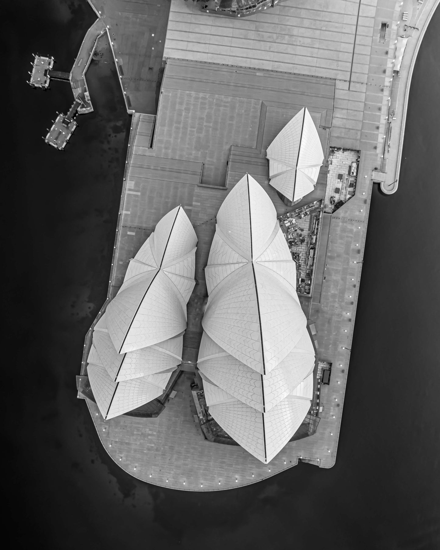 Aerial black and white photograph of the Sydney Opera House from directly above at dusk, by Nicolas Letoublon