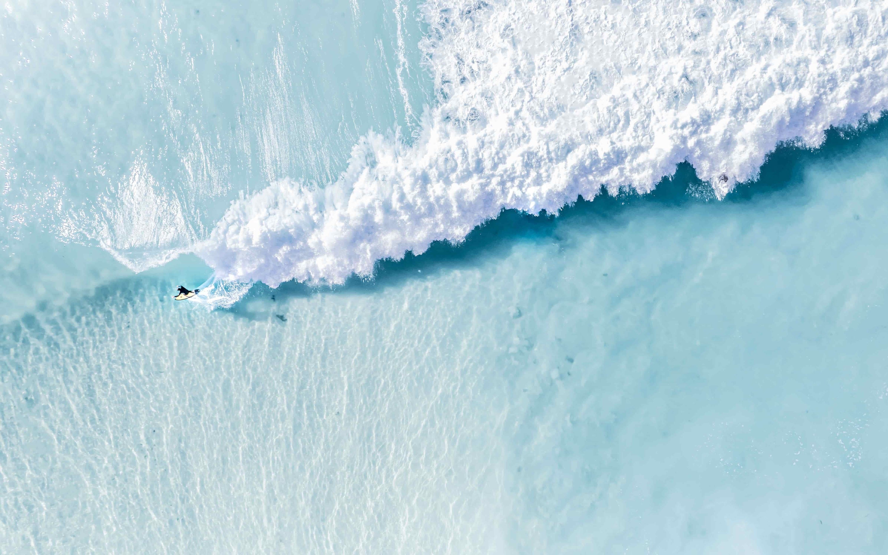 Aerial photograph of a surfer on a breaking wave, Australian coast, by Nicolas Letoublon