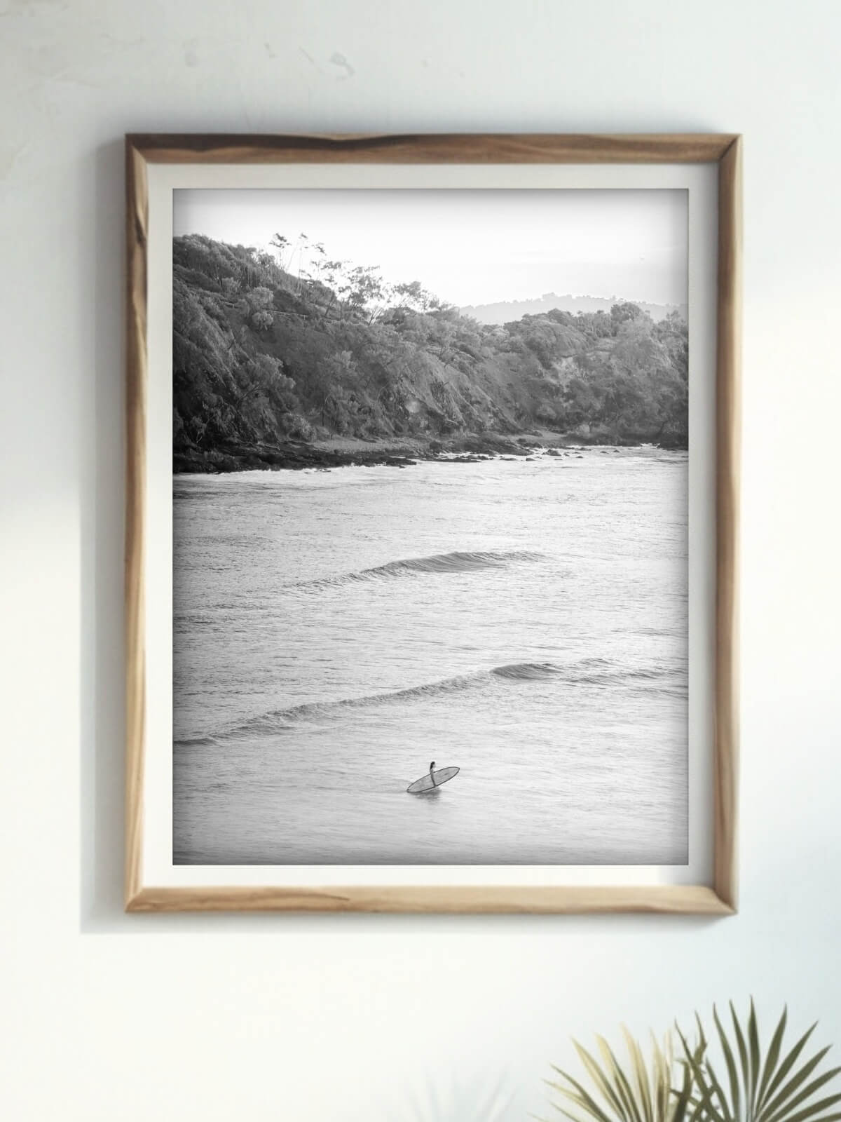 Framed black and white photography print of Wategos Beach Byron Bay displayed on a wall