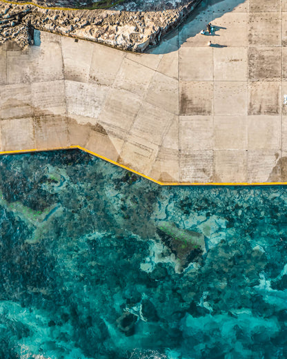 Aerial view of Clovelly Beach Sydney showing geometric concrete platform and turquoise reef water