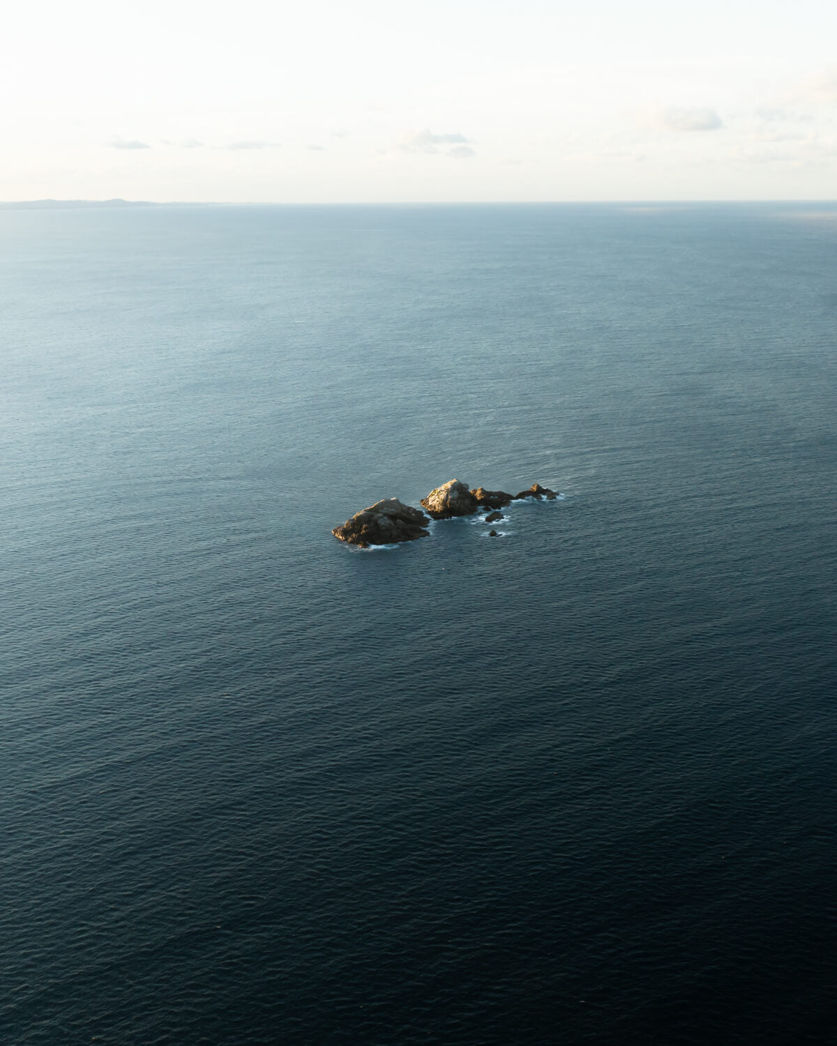 Aerial view of Julian Rocks in the open ocean off Byron Bay, NSW Australia