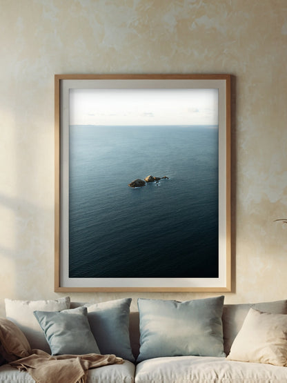 Framed aerial coastal photography print of Julian Rocks Byron Bay on a wall