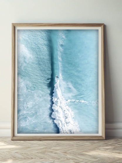 Framed aerial surf photography print of Byron Bay displayed on a wall
