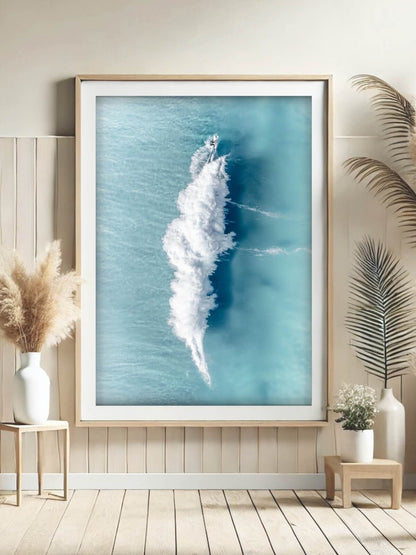 Framed aerial surf photography print of a surfer's wake at Bronte Beach on a wall