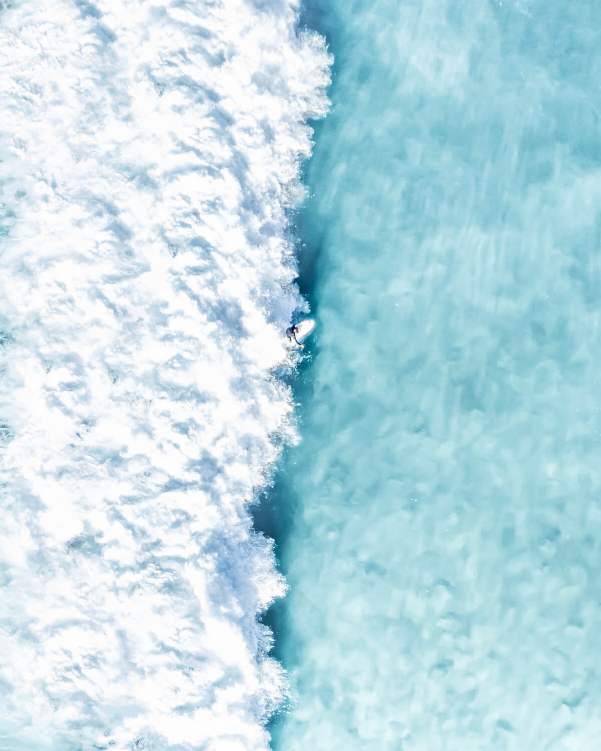Aerial view of a surfer riding a diagonal wave at Bronte Beach, Sydney
