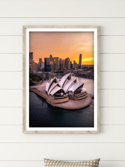 Framed aerial photography print of the Sydney Opera House at twilight on a wall