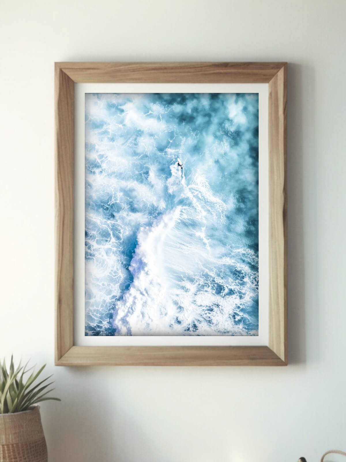 Framed aerial surf photography print of a breaking wave at Bronte Beach on a wall