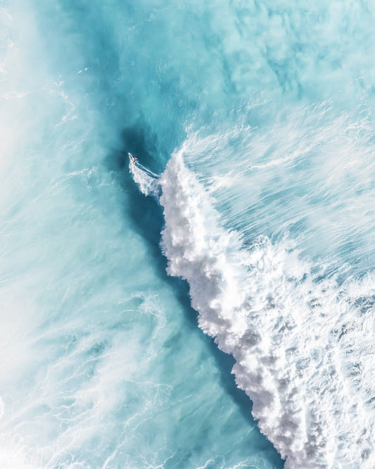 Aerial view of a surfer on a large breaking wave along the NSW coast, Australia