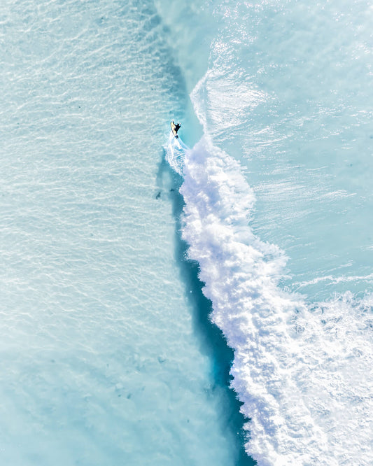 Aerial view of a lone surfer at The Pass, Byron Bay, NSW Australia