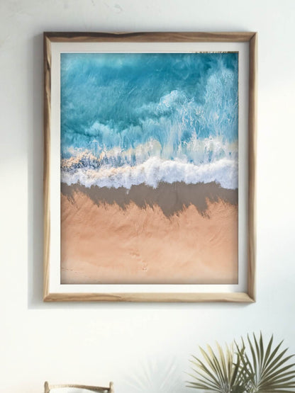 Framed aerial coastal photography print of a wave on the NSW coast displayed on a wall