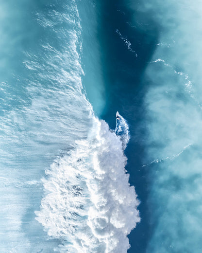 Aerial view of a surfer on a heavy wave at The Farm beach, Killalea, NSW Australia