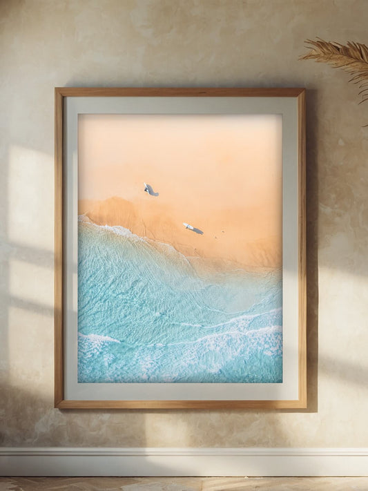 Framed aerial surf photography print of The Pass Byron Bay on a wall
